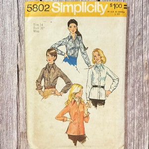 May include: Vintage Simplicity sewing pattern number 5802 for a blouse. The pattern is for size 14, bust 36, and is for misses. The pattern shows four different styles of blouses with long sleeves and collars.