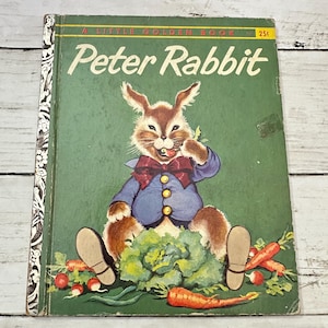 May include: Vintage "Peter Rabbit" Little Golden Book. The cover features a smiling rabbit in a blue jacket and red bow tie, surrounded by vegetables on a green background. The book's title is in white, with a yellow price tag in the upper right corner.
