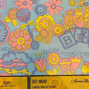May include: Blue and yellow baby gift wrap with a floral pattern and the text "babies come from" and "American Greetings".