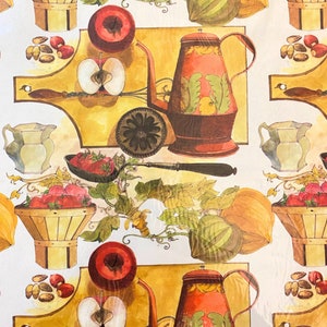 May include: A vintage-style wrapping paper design featuring a repeating pattern of red apples, strawberries, pumpkins, and a brown teapot with green and yellow floral designs. The background is a yellow-gold colour. The text "Hallmark Cards, Inc. Made in USA" is at the bottom of the design.