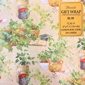 May include: Floral gift wrap with a beige background and a repeating pattern of green ivy, potted plants, and books. The text "Flourish Gift Wrap" is printed in gold on a yellow rectangle with the price "&pound;1.10" and the size "7 1/2 sq. ft. (2 1/2 ft. x 1 yd. 4 in.) (2 sheets 26 in. x 20 in.) (or larger)".
