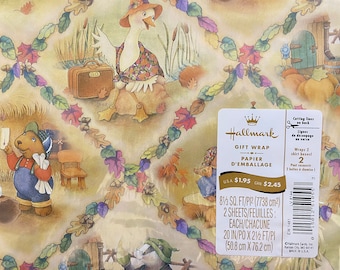 May include: Hallmark gift wrap featuring a whimsical illustration of a goose with a suitcase and a bear with a letter. The paper is decorated with a garland of colorful leaves. The text on the label reads "Gift Wrap - Papier d'Emballage" and includes the price: "USA $1.95 CAN $2.45". The label also includes the size of the paper: "8 1/3 sq. ft/pi2 (7738 cm2)".