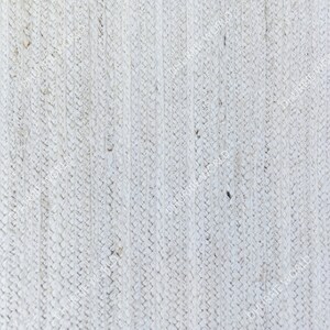 Op de afbeelding: Wit geweven stof met een textuur, gevlochten patroon. De stof heeft een licht ruwe, natuurlijke uitstraling.