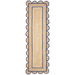 May include: A natural fiber table runner with a scalloped edge and a blue border. The runner is made of jute and has a subtle texture. The text "DHURRIE WORLD" is printed on the runner.