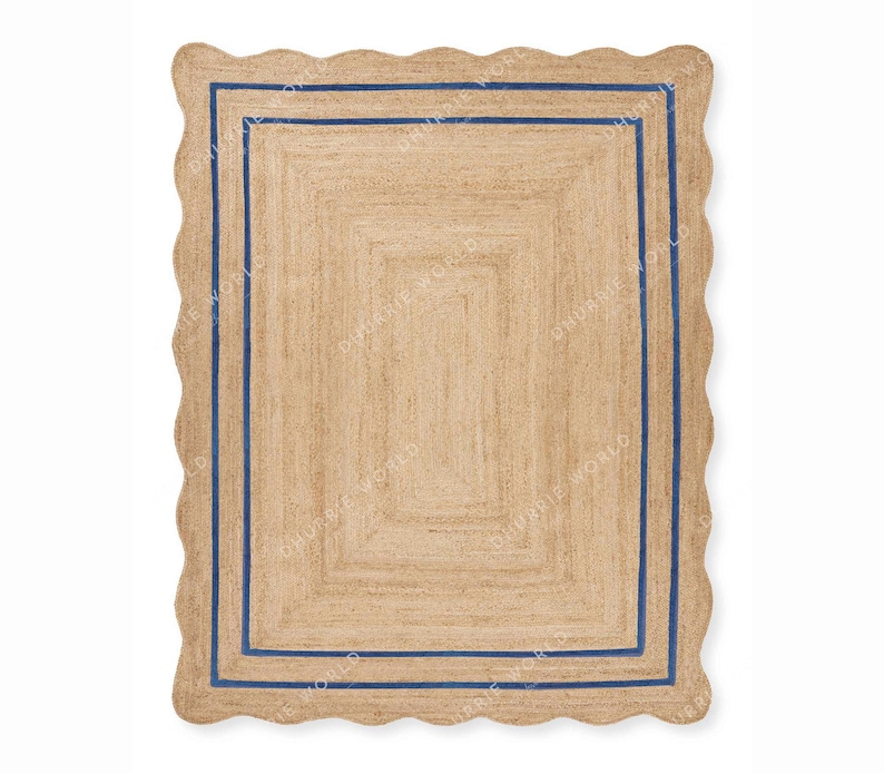 May include: A natural fiber rug with a scalloped edge and a double blue border. The rug is made of jute and has a natural, earthy color.