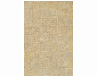 May include: A natural fiber rug with a square pattern in a light beige color. The rug is made of jute and has a woven texture.
