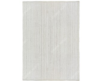 May include: A white woven rug with a textured surface. The rug has a rectangular shape and is made of natural fibers.