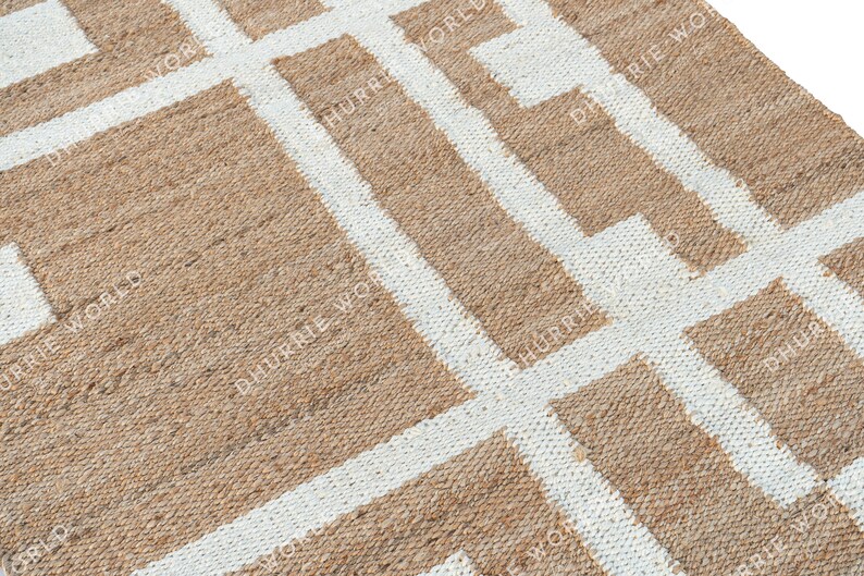 May include: A natural fiber rug with a geometric pattern of white lines on a brown background.