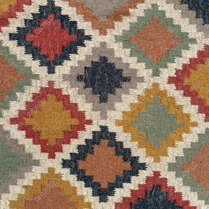 May include: A colorful rug with a geometric pattern in shades of red, orange, yellow, green, blue, and gray. The rug has a woven texture and a diamond-shaped design.