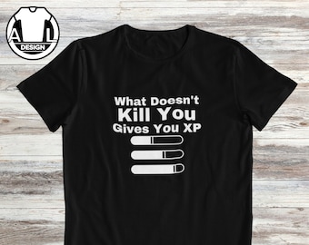 May include: Black t-shirt with white text that reads "What Doesn't Kill You Gives You XP" and three white progress bars underneath.