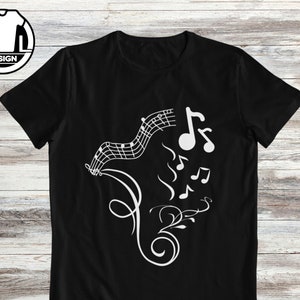 Puede incluir: Camiseta negra con un diseño blanco de notas musicales y un patrón floral.