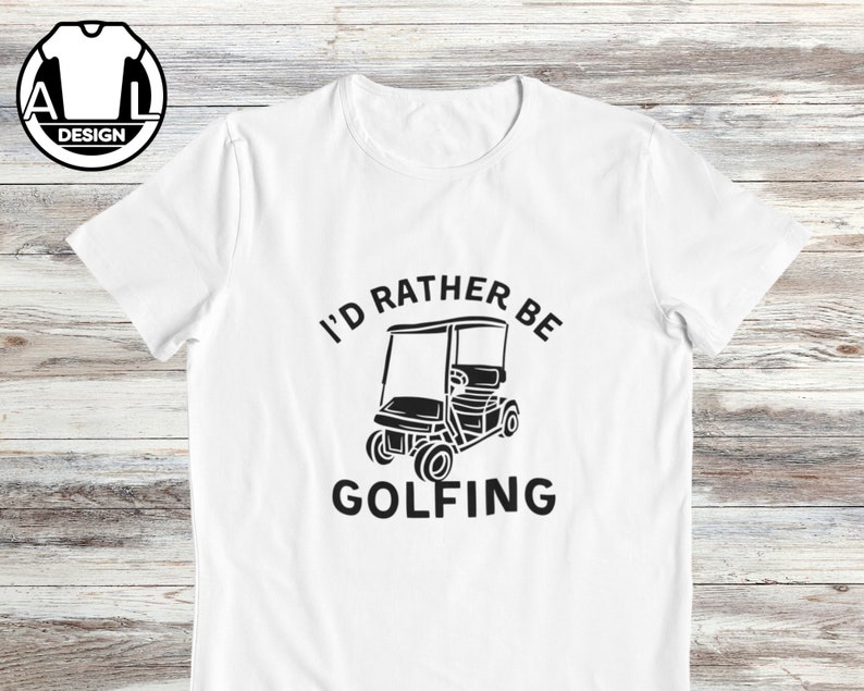 May include: White t-shirt with black text that reads "I'd rather be golfing" and a black silhouette of a golf cart.