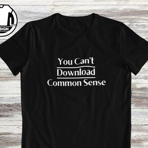 May include: Black t-shirt with white text that reads "You Can't Download Common Sense".