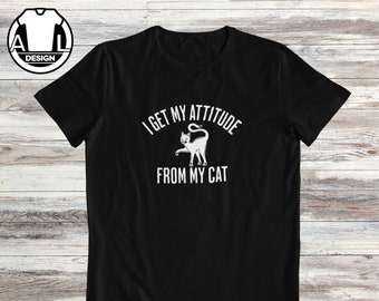 May include: Black t-shirt with a white graphic of a cat and the text "I get my attitude from my cat."