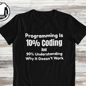 May include: A black short-sleeved t-shirt featuring white text that reads: Programming Is 10% Coding And 90% Understanding Why It Doesn't Work. A circular logo with the letters A and L and a t-shirt icon is positioned in the top left corner.