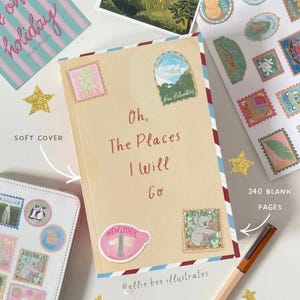 May include: A travel-themed journal with the title "Oh, The Places I Will Go" and various stickers resembling postage stamps. The journal has 240 blank pages and is decorated with stamps from Italy, Australia, and New York. A pen and star-shaped glitter are also present.