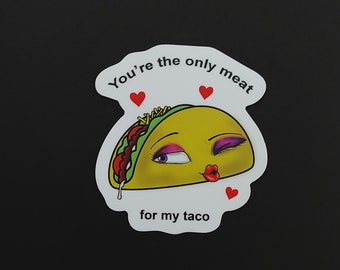 May include: White sticker with a cartoon taco winking and puckering its lips. The taco has a green lettuce, red tomato, and brown meat filling. The text reads "You're the only meat for my taco" with three red hearts.