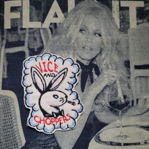 May include: Embroidered patch featuring a white bunny smoking a cigarette, with the words "VICE AND CHOPPERS" in red and blue. The patch is on a denim background with a black and white image of a woman.