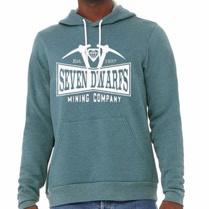 May include: A teal blue hooded sweatshirt with a white graphic print of a diamond, two pickaxes, and the text "Est. 1937 Seven Dwarfs Mining Company".