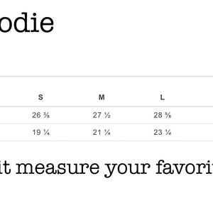 May include: Unisex hoodie size chart showing measurements in inches for XS, S, M, L, XL, and 2XL sizes. The chart shows full body length and body width measurements.