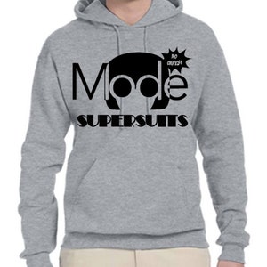 May include: A gray hooded sweatshirt with a black graphic design that says "Mode Supersuits" with a cartoon head wearing headphones and a speech bubble that says "No capes!"