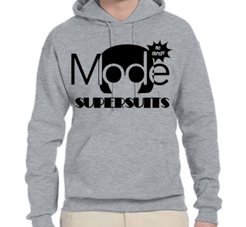 May include: A gray hooded sweatshirt with a black graphic design that says "Mode Supersuits" with a cartoon head wearing headphones and a speech bubble that says "No capes!"