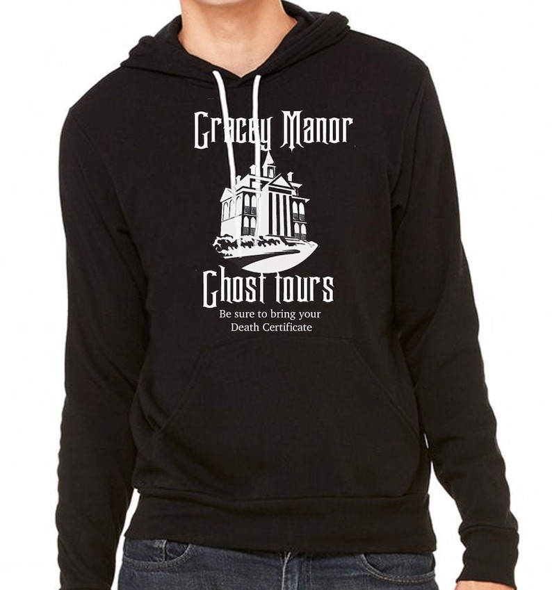 May include: Black hooded sweatshirt with a white graphic design of a spooky house with the text "Gracey Manor Ghost Tours" and the tagline "Be sure to bring your Death Certificate".