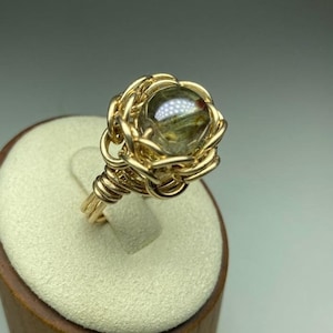 Wrapped brass ring with nested crystal ball. Solitaire ring. Flower ring. Handmade, dainty ring. Boho ring.