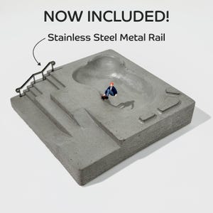 May include: A miniature concrete skatepark with a bowl, stairs, and a ramp. A miniature figure of a person is skateboarding in the bowl. The skatepark includes a stainless steel metal rail.