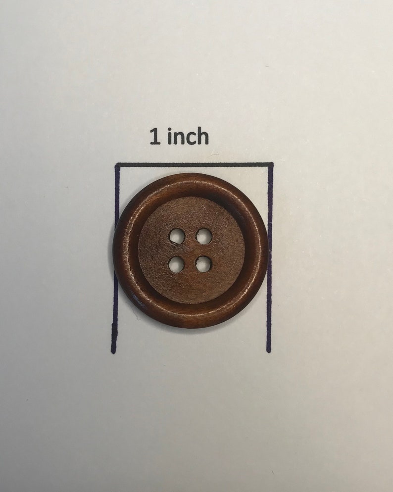 May include: A round, brown wooden button with four holes, measuring 1 inch in diameter. The button is set against a white background with a black outline and the text "1 inch".