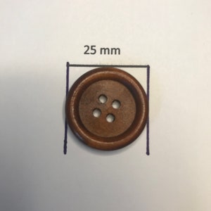 May include: A round, brown wooden button with four holes. The button is 25 mm in diameter, as indicated by the text and measurement lines. The button is set against a white background.