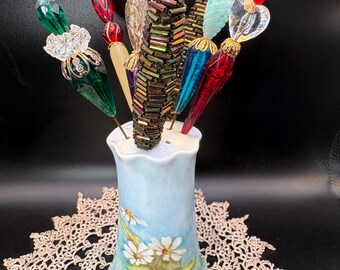 Vintage collection of vintage hat pins in a hand painted porcelain holder