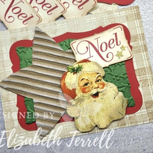May include: A Christmas card with a red border and a green background. The card features a vintage illustration of Santa Claus, a star, and the word "Noel" in a decorative font.