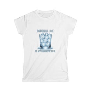 May include: White t-shirt featuring a graphic of a glass filled with ice cubes. The text above the glass reads "CRUSHED I.C.E." and below it says "IS MY FAVORITE I.C.E."