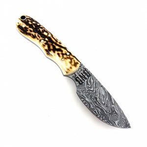 May include: A hunting knife with a brown and white stag horn handle and a Damascus steel blade. The blade is etched with the word "ONWARD".