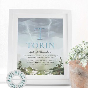 May include: Framed art print featuring the name "Torin" with a watercolor landscape and lightning background. The text describes the name's origins and associated traits: authoritative, powerful, tough, tenacious, wealthy, problem-solver, and strong-willed.