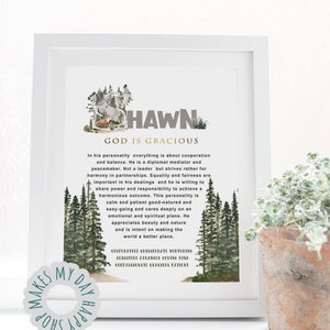 May include: White framed art print with the name "HAWN" and the phrase "GOD IS GRACIOUS" in a decorative font. The print includes a forest scene and descriptive text about the name's personality traits. A small plant in a terracotta pot is in the foreground.