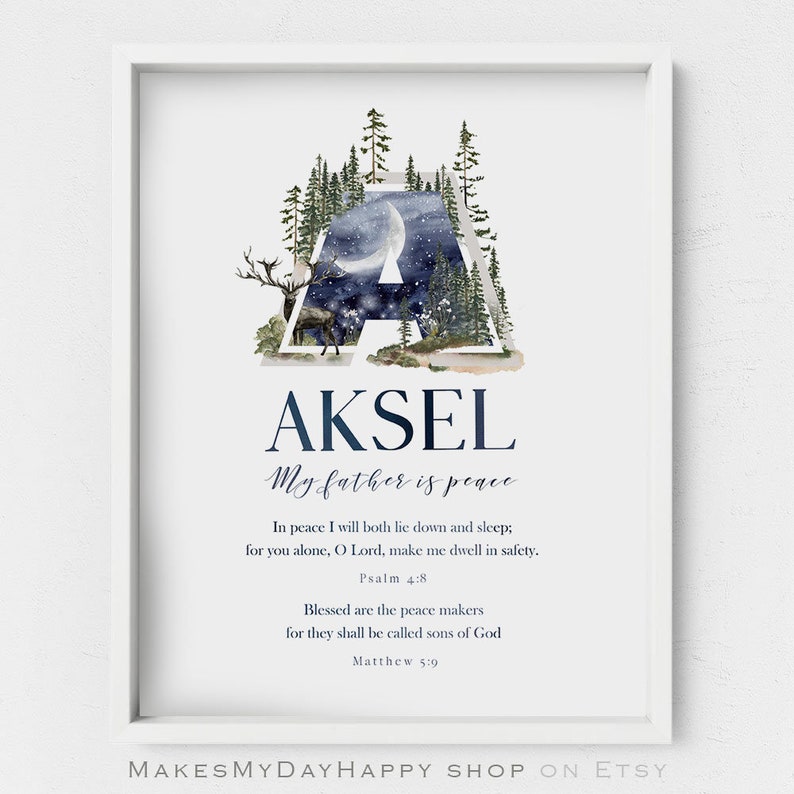 May include: A framed print featuring the name "AKSEL" in navy blue script. The letter "A" is filled with a watercolor illustration of a forest scene with a deer and a night sky. The print includes Bible verses and the phrase "My father is peace."