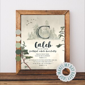 May include: A framed print featuring the name "Caleb" in a script font, with the words "Ancient Hebrew" and "faithful whole-heartedly" below. The artwork includes a forest scene with a large "C" and text from Numbers 13:6 and 13:30. The frame is made of wood.