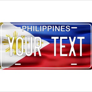 May include: A white license plate with a blue, red, and white Philippine flag background. The text "PHILIPPINES" is printed in black at the top of the plate. The text "YOUR TEXT" is printed in white in the center of the plate.