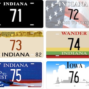 May include: Six license plates are displayed, featuring the states of Indiana and Iowa. Each plate has a large number and the state name. Some plates include additional text such as "In God We Trust". The plates have different colour schemes.