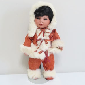 Vintage porcelain Eskimo baby girl doll with movable head and arms
