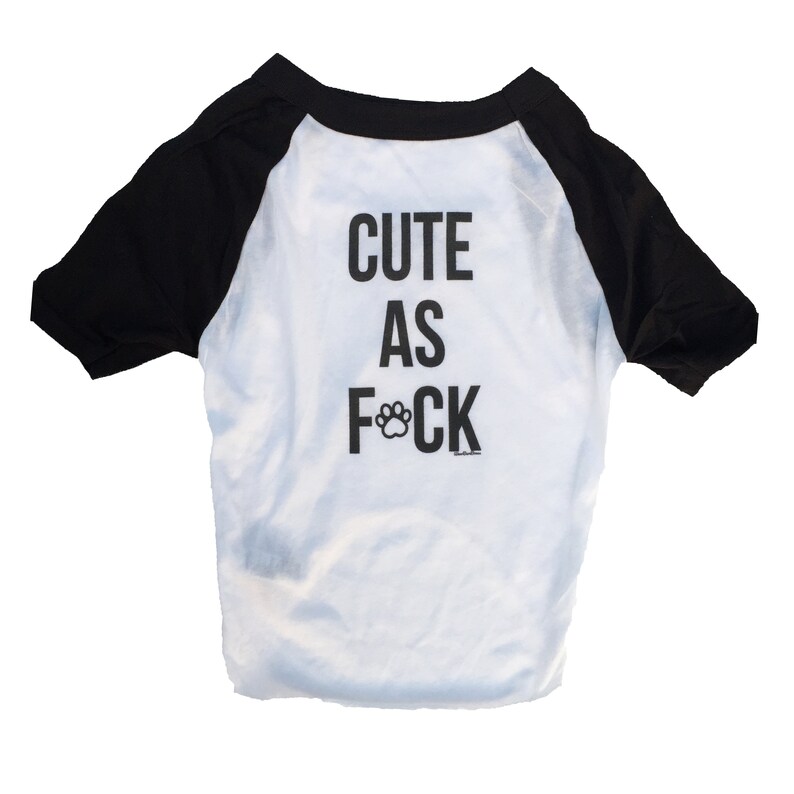 May include: White and black dog t-shirt with the text "Cute as F*ck" with a paw print replacing the "C".
