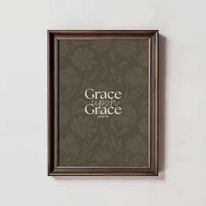 May include: A framed print with a brown floral pattern and the text "Grace upon Grace" with the scripture reference "John 1:16" underneath.