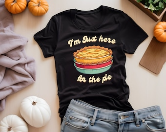 May include: Black t-shirt with a graphic of a pie in a dish and the text "I'm just here for the pie".