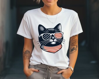 May include: White t-shirt with a black cat wearing sunglasses with an American flag design and a red, white, and blue bandana.