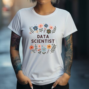 May include: White t-shirt with a floral design and the text "DATA SCIENTIST" in brown.