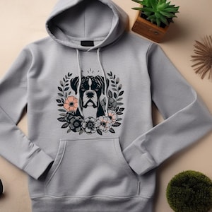 May include: A gray hooded sweatshirt with a black boxer dog illustration surrounded by flowers. The dog has a black nose and black eyes. The flowers are pink, white, and black.