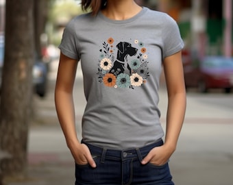 Può includere: Una maglietta grigia con un'illustrazione in bianco e nero di un cane con fiori in un motivo floreale.