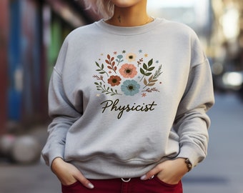 May include: A grey sweatshirt with a floral design and the word "Physicist" printed on the front.